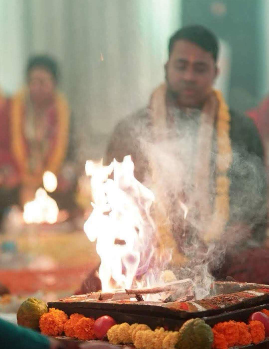 Satguru Manash Mishra Ji seated before a sacred fire during a havan